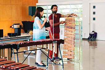 Two people explain folk instruments